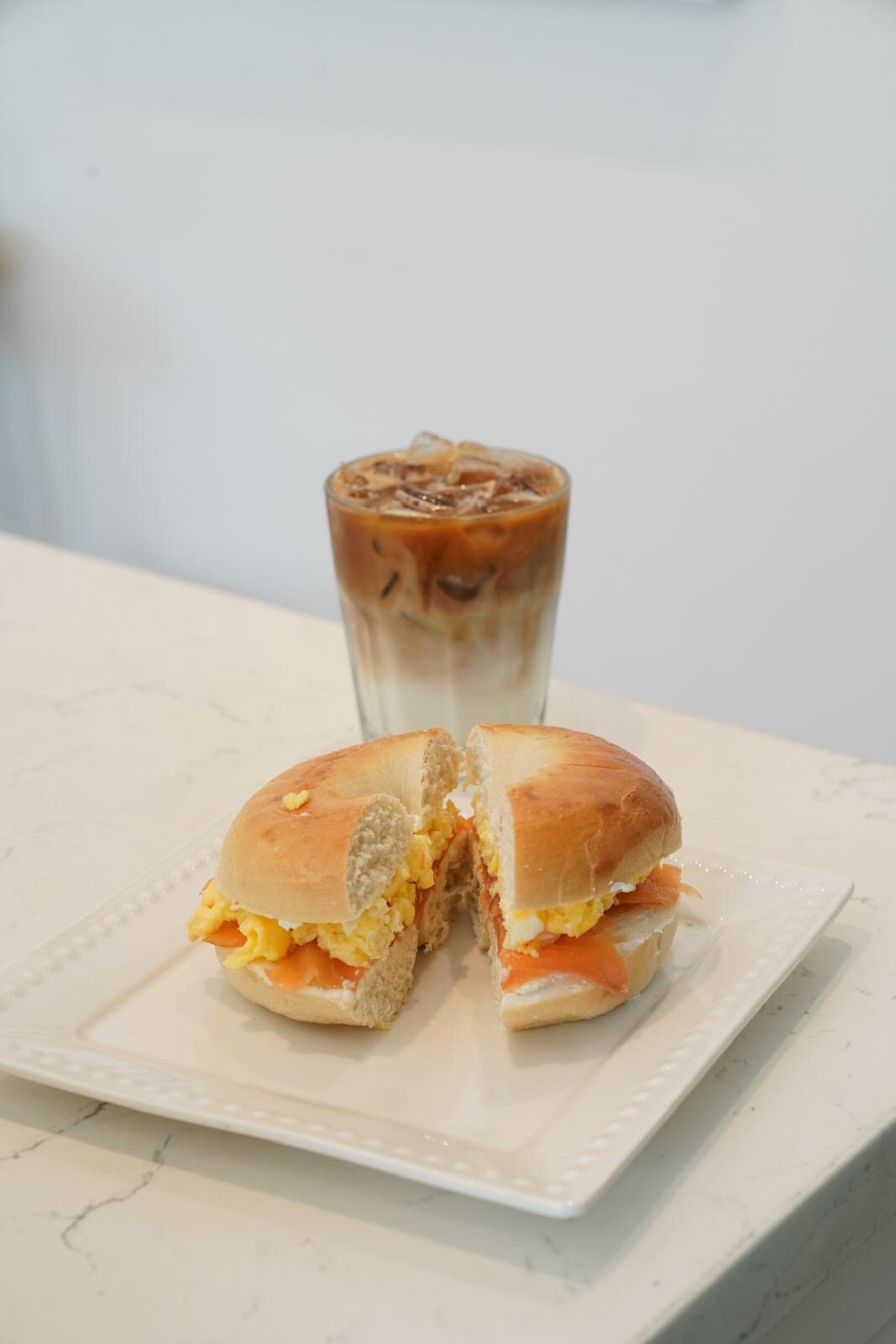A breakfast bagel sandwich plated at Isaiah Café